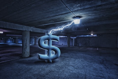 Dollar sign electrifying light in parking lot