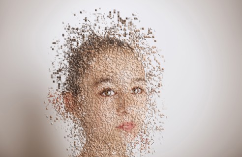 Pixelated mixed race girl with serious expression