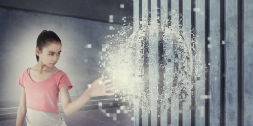 Mixed race girl touching pixelated sphere