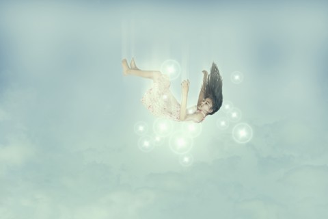 Mixed race girl falling in sky