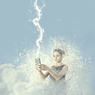 Mixed race girl holding cell phone in lightning