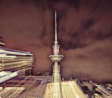 Double exposure of cityscape and cloudy sky