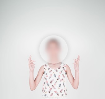 Mixed race girl with face obscured by sphere