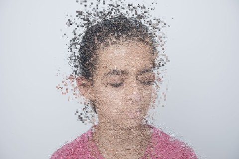 Mixed race boy with pixelated face