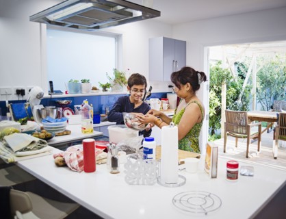 Mother and son cooking in kitchen