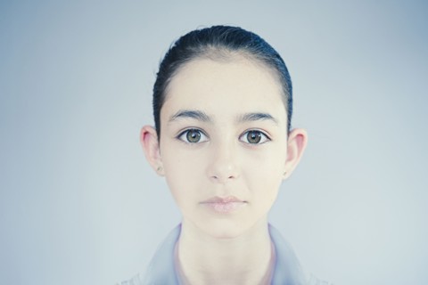 Face of wide-eyed Mixed Race girl