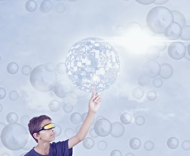 Mixed Race boy using vr goggles touching hovering pixel sphere