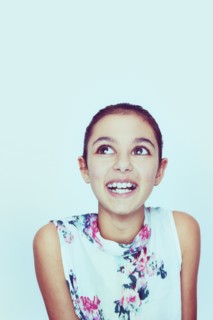 Portrait of smiling Mixed Race girl with big eyes
