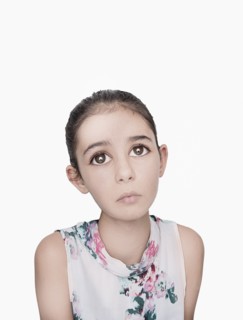 Portrait of sad Mixed Race girl with big eyes