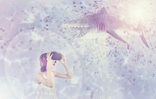Mixed Race girl using virtual reality goggles watching shark