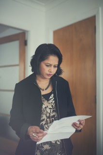 Indian woman reading paperwork