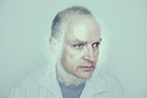 Face of Caucasian man in cyberspace