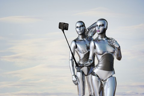 Robot couple posing for cell phone selfie