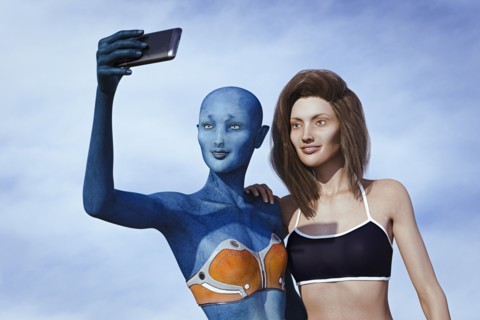 Woman and alien posing for cell phone selfie
