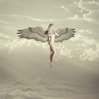 Woman angel flying in clouds