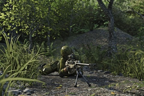 Futuristic soldier laying on the ground aiming rifle