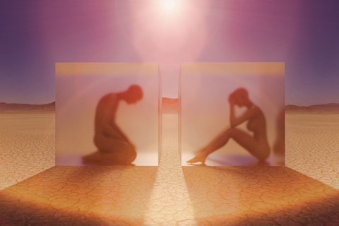 Separated couple in suspended animation in desert