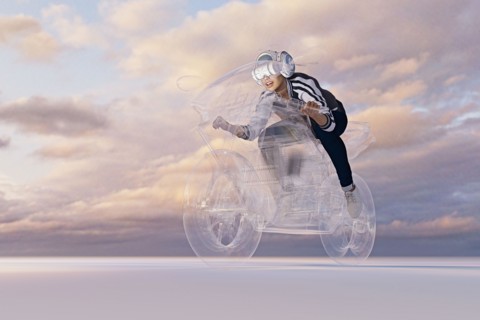 Woman wearing virtual reality helmet riding motorcycle