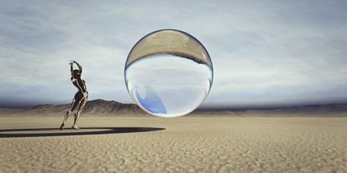 Futuristic woman watching floating sphere in desert