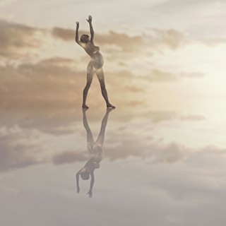 Futuristic expectant mother standing in clouds