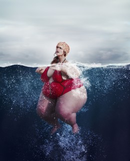Underwater review of overweight woman swimming