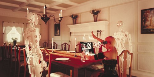 Robots watching woman at dining table wearing virtual reality goggles
