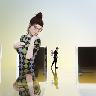 Businesswoman watching windup businessman toy