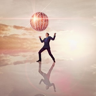 Businessman watching floating sphere of binary code