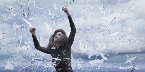 Shards of glass falling on woman