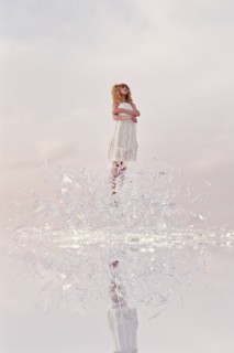Woman hovering in shards of glass