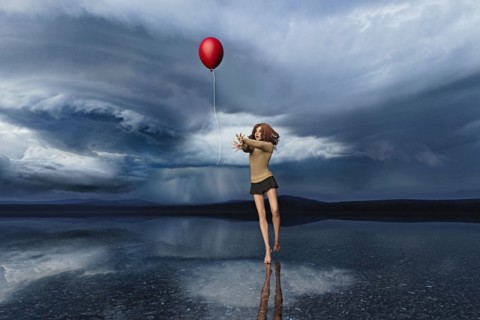 Girl chasing red balloon