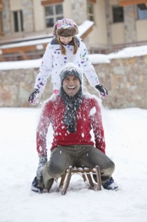 Father and daughter playing in snow