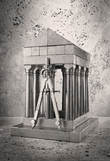 Silver model of pillars and archway with compass