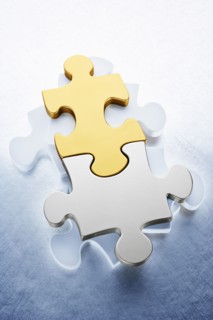 Close up of gold and silver puzzle pieces