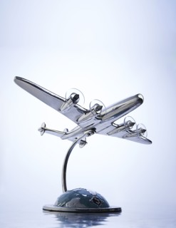 Model of airplane flying over globe