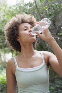 Mixed race woman drinking water
