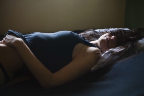 Sleeping mixed race woman laying in bed