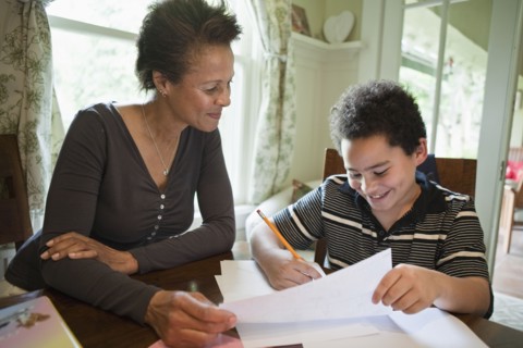 Grandmother helping grandson with homework