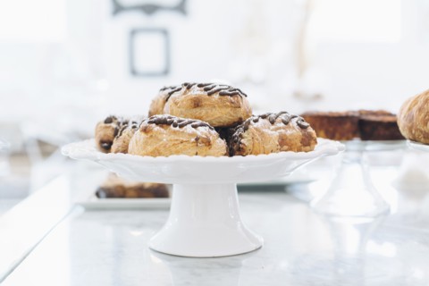 Close up of platter of donuts on cafe counter