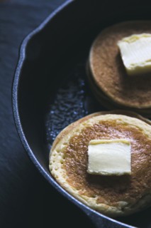Close up of butter on pancakes in pan