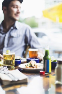 Caucasian man eating tacos in restaurant