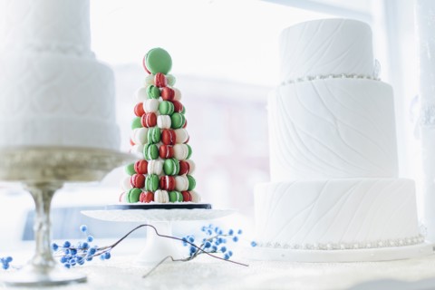 Macaroon and wedding cakes in bakery window