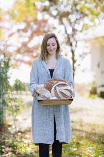 Caucasian woman holding bread outdoors