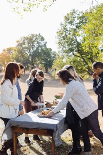 Friends setting outdoor dining table