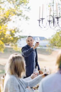 Friends toasting with wine at outdoor table