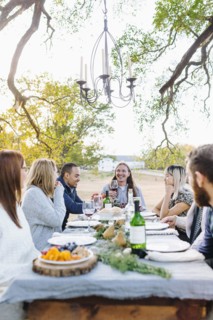 Friends drinking wine at outdoor table