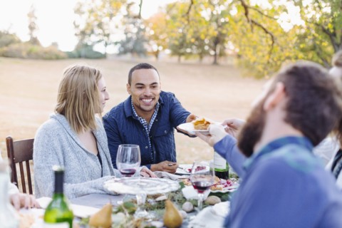 Friends eating pie at outdoor table