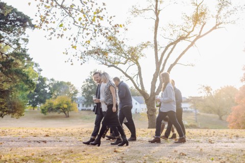 Friends walking in rural field