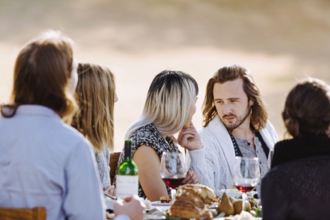 Friends eating at outdoor table