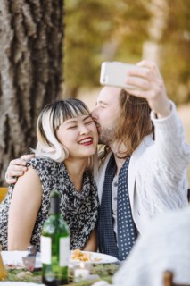 Couple taking selfie at outdoor table